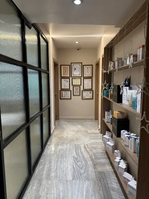 Corridor with skincare shelves and certificates